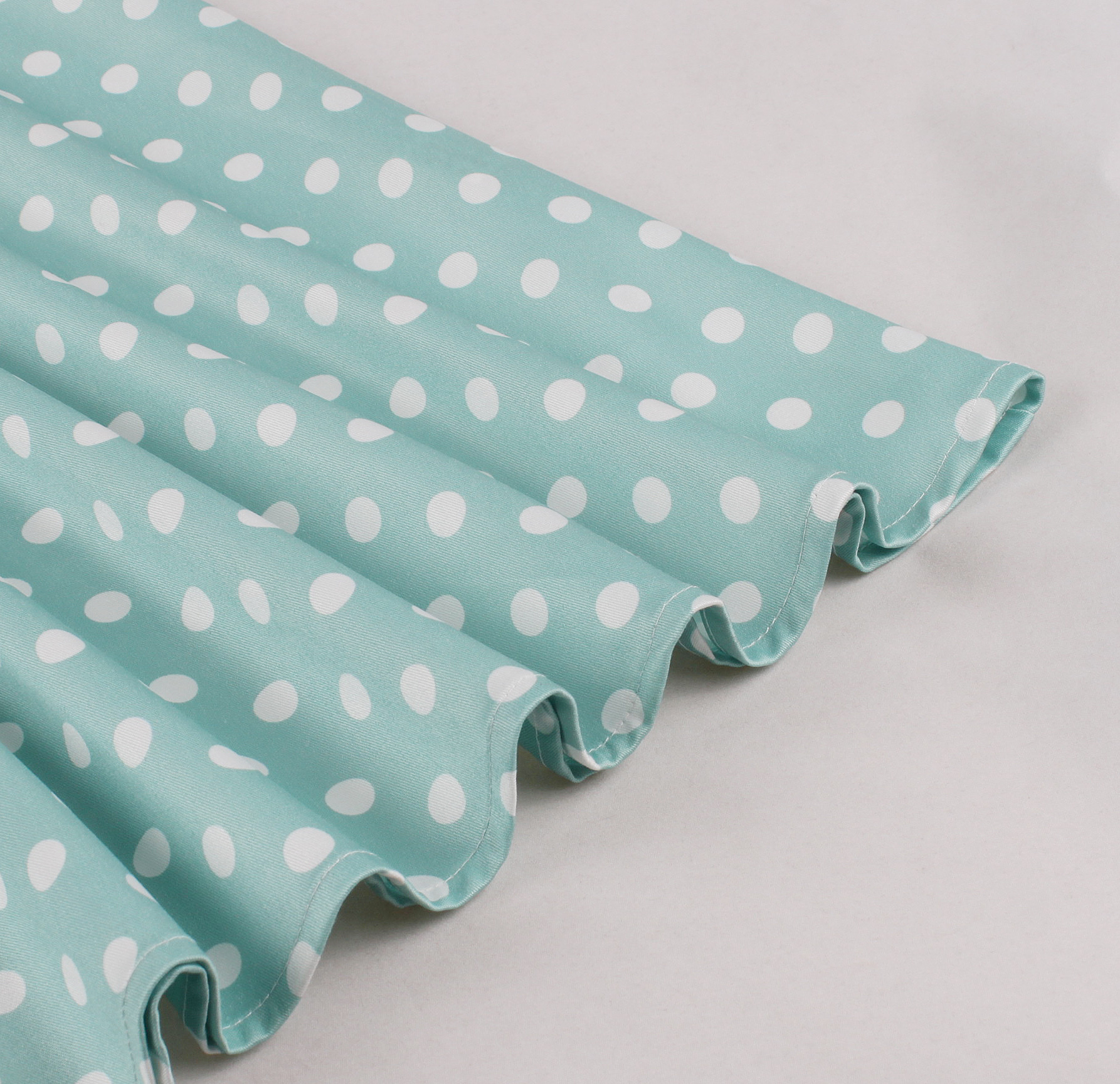 Vintage style, Green with white polka dots, Short sleeves, V-neckline, White lace trim, Chest bow accent, Cinched waist belt, A-line skirt, Lightweight fabric, Comfortable fit #N23827