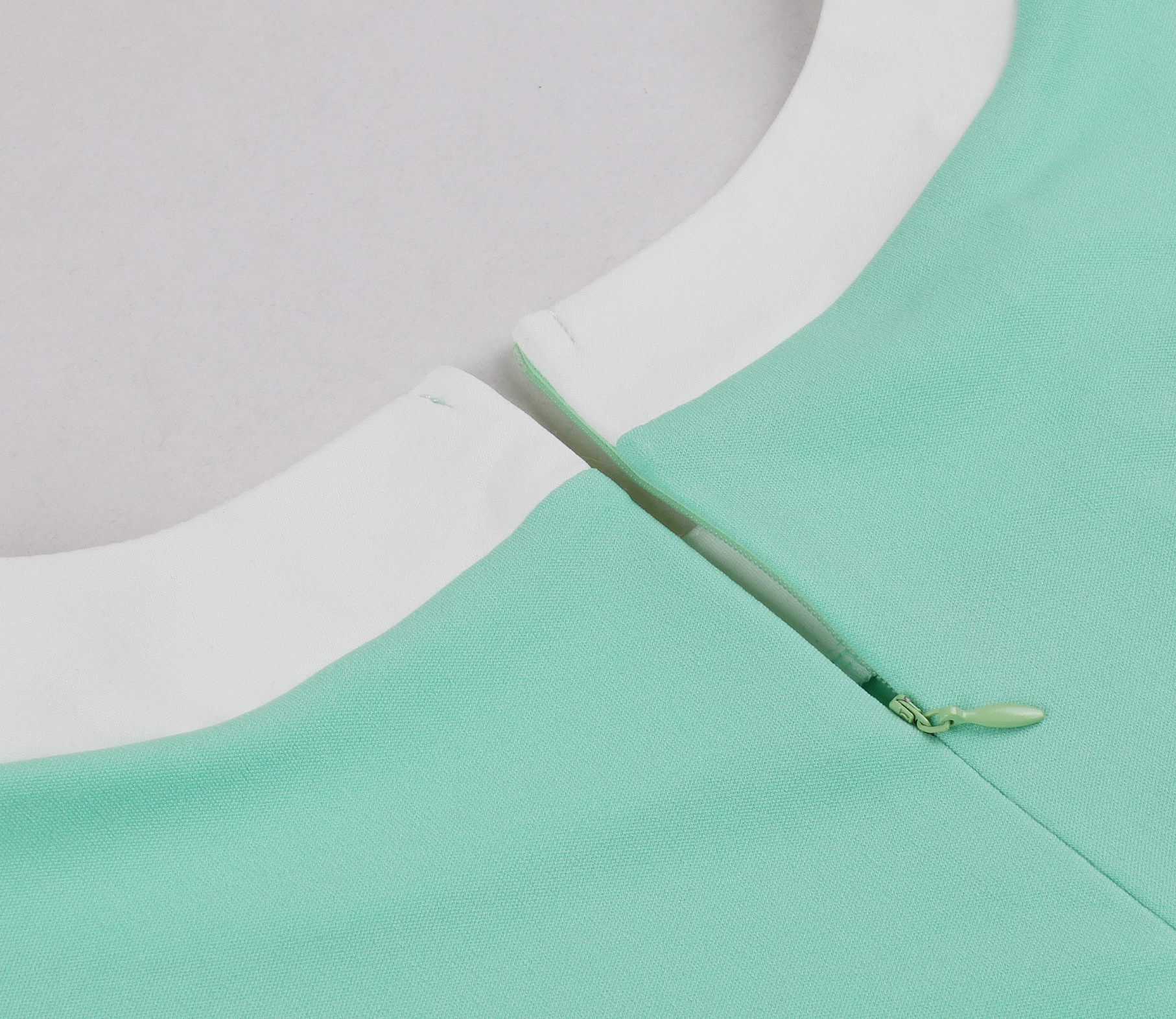 Vintage style, Mint green color, Short sleeve, White collar and belt, Decorative bow with black buttons, Flared A-line skirt, Matching headband included, Comfortable fabric, Perfect for themed events, Easy-to-wear classic design #N23819