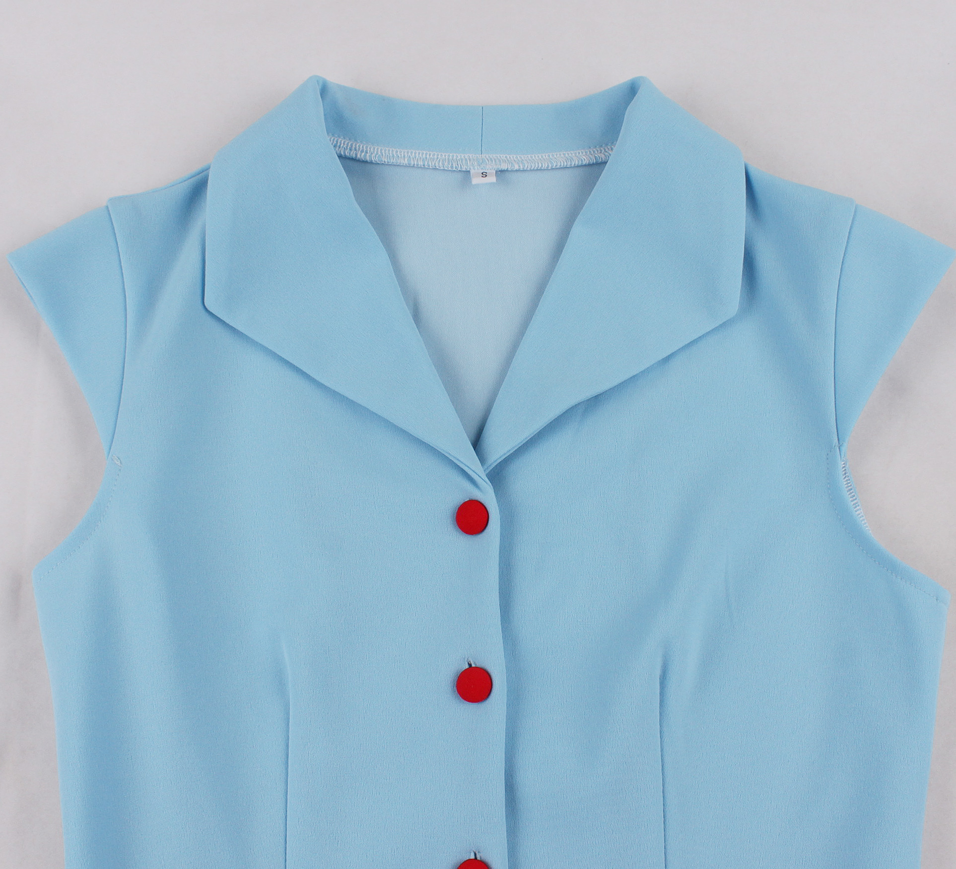 Vintage style, Royal blue color, White contrast belt, Five front buttons, A-line skirt, Sleeveless design, Lightweight fabric, Shift dress silhouette, Classic retro fashion, Easy to wear #N23823